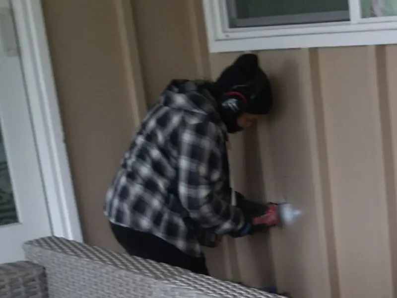 Professional electrician installing an exterior outlet in Islandia